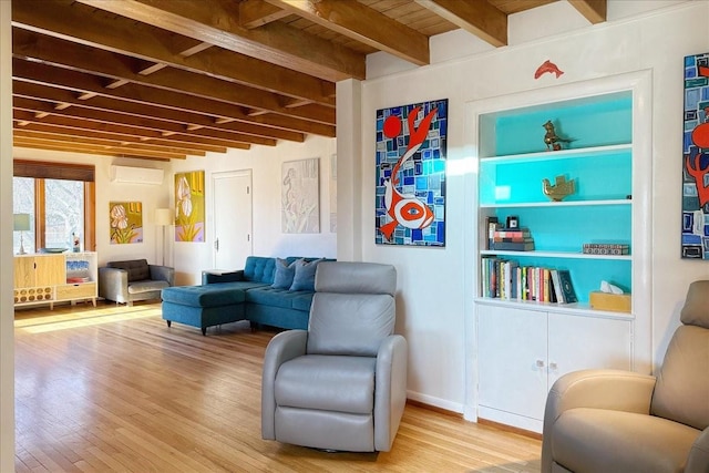 sitting room with hardwood / wood-style flooring and beam ceiling