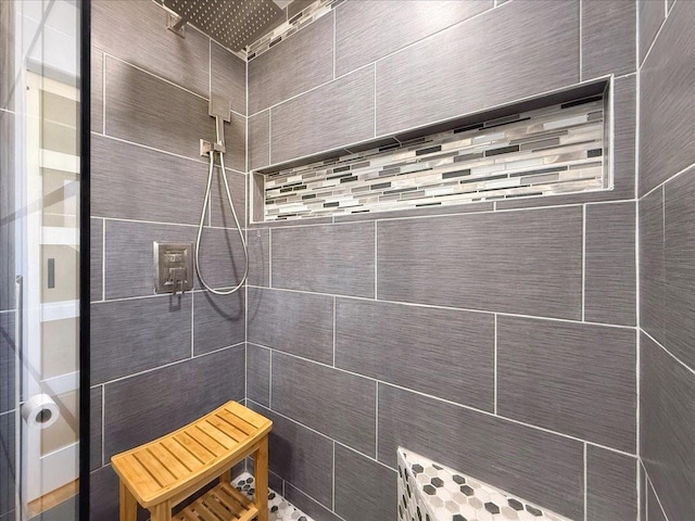 bathroom with a tile shower