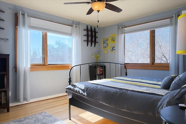 bedroom with ceiling fan and hardwood / wood-style floors