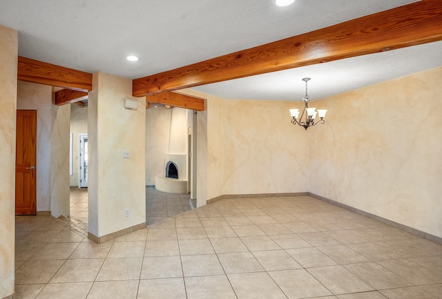 spare room featuring light tile patterned floors, a notable chandelier, and beam ceiling