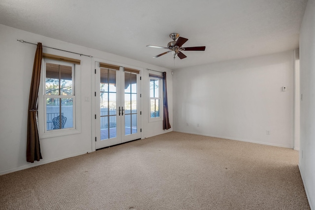 carpeted empty room featuring french doors and ceiling fan