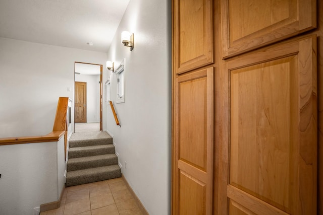 stairway featuring tile patterned flooring