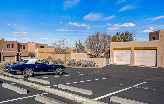 view of vehicle parking featuring a garage