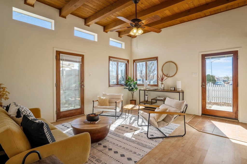 sitting room with a healthy amount of sunlight, wooden ceiling, and beam ceiling