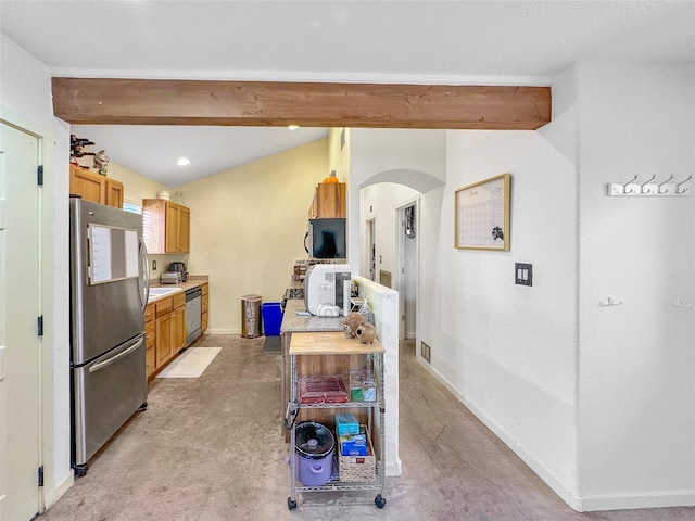 kitchen featuring vaulted ceiling with beams and stainless steel appliances