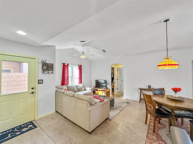 living room featuring lofted ceiling, concrete floors, and ceiling fan