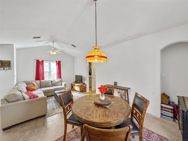 dining area with vaulted ceiling, light colored carpet, and ceiling fan