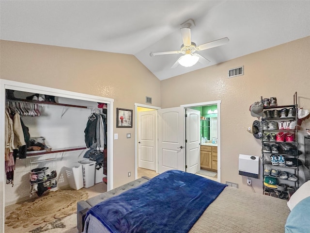 bedroom with connected bathroom, vaulted ceiling, a closet, and ceiling fan