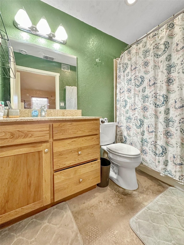 bathroom featuring vanity, toilet, and concrete floors