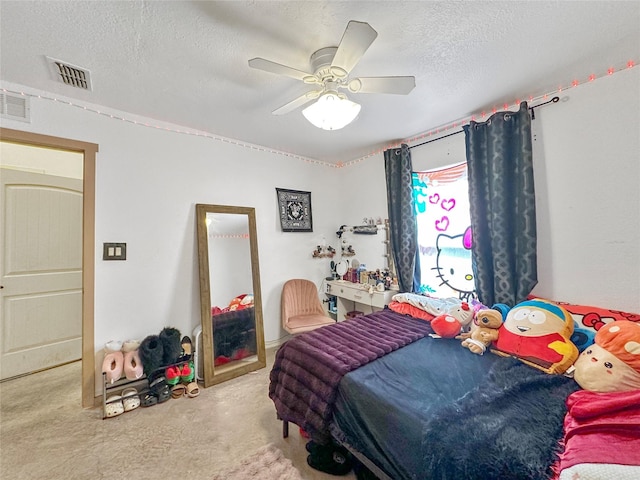 carpeted bedroom with ceiling fan and a textured ceiling