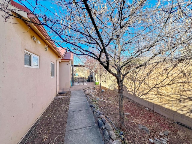 view of side of property with a patio area