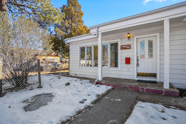 view of snow covered property entrance