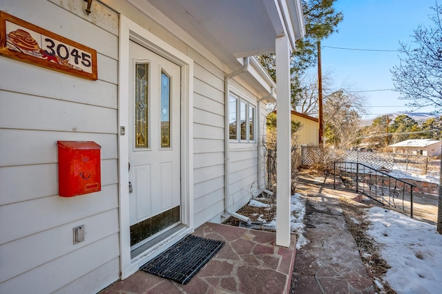 view of snow covered property entrance