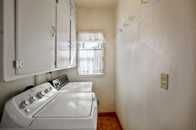 laundry area featuring cabinets and washing machine and clothes dryer