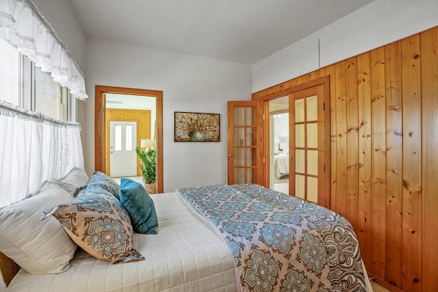 bedroom featuring wooden walls