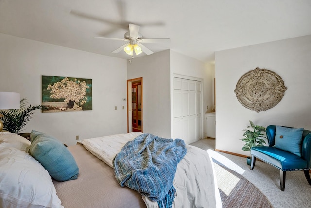 carpeted bedroom featuring ceiling fan and a closet