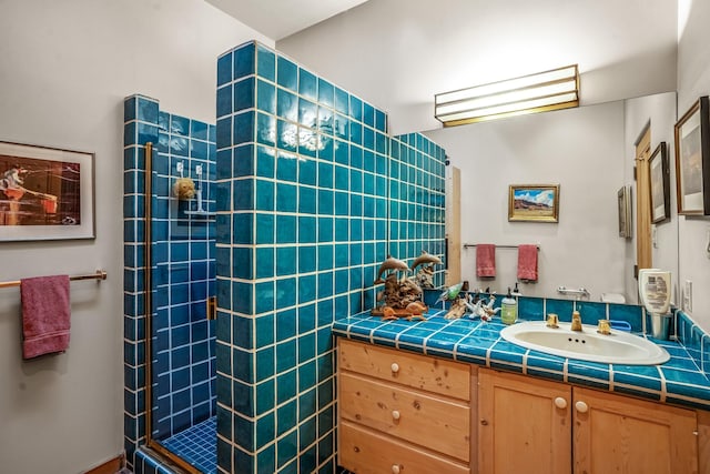 bathroom featuring vanity and a tile shower