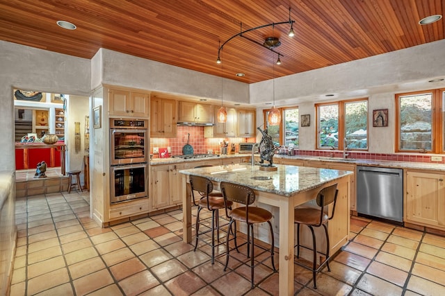 kitchen featuring wood ceiling, light brown cabinets, an island with sink, pendant lighting, and stainless steel appliances