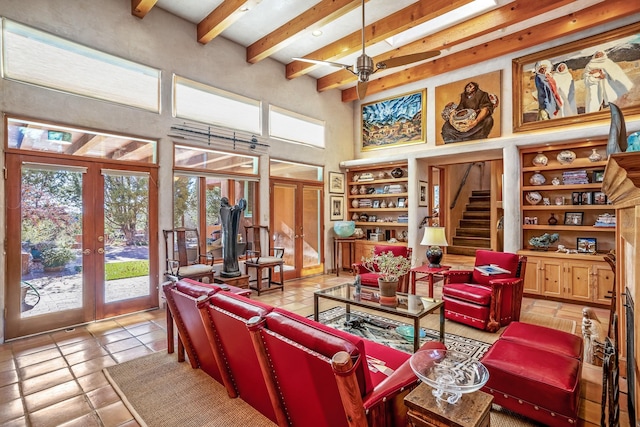 living room featuring a towering ceiling, light tile patterned floors, ceiling fan, beam ceiling, and french doors