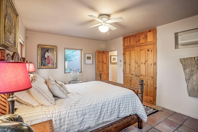 tiled bedroom featuring a wall mounted air conditioner and ceiling fan