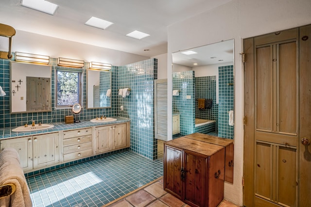 bathroom with tile patterned flooring, vanity, and tile walls