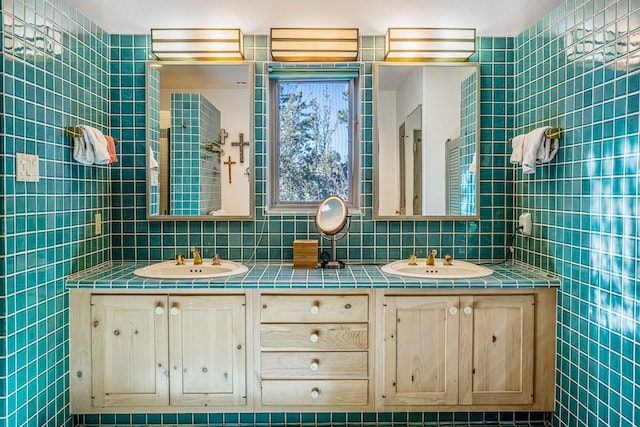 bathroom featuring vanity and tile walls