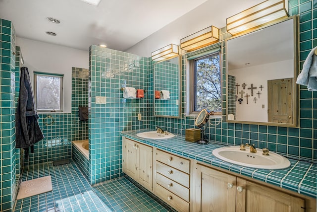 bathroom with vanity, separate shower and tub, tile walls, and tile patterned floors