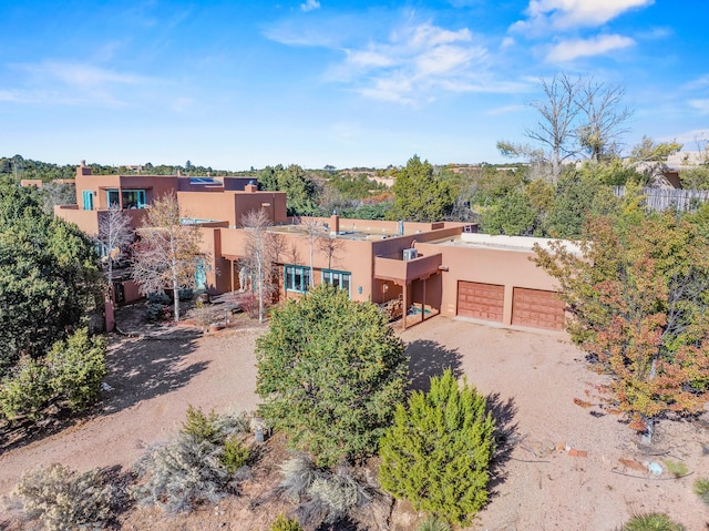 pueblo-style home featuring a garage