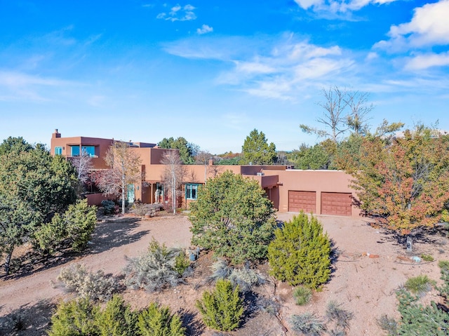 pueblo-style house with a garage