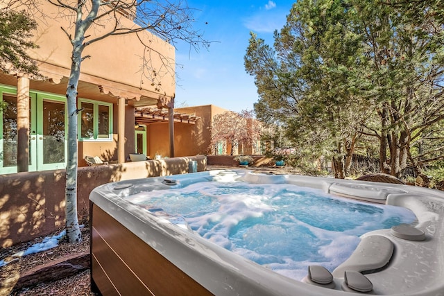 view of pool with a hot tub