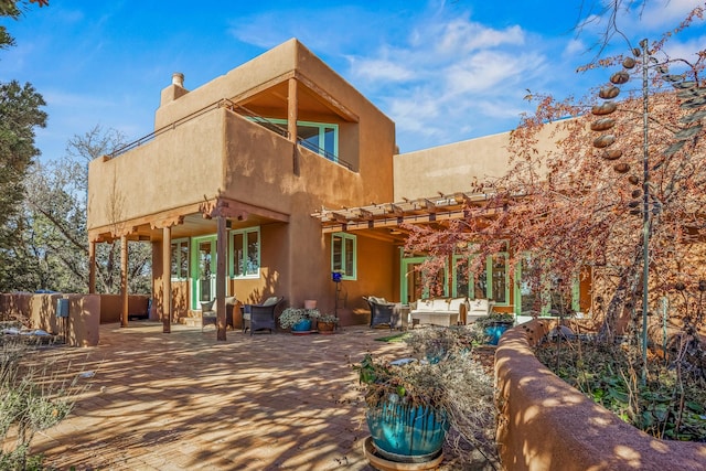 rear view of house featuring an outdoor hangout area and a patio