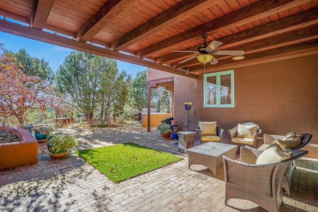 view of patio with ceiling fan, outdoor lounge area, and a jacuzzi