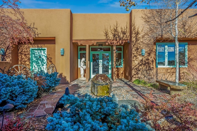 view of exterior entry featuring french doors