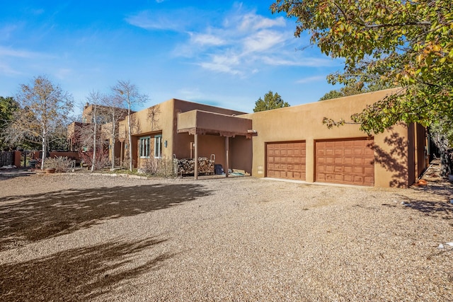 pueblo-style home featuring a garage