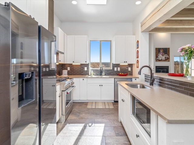 kitchen featuring white cabinetry, stainless steel appliances, and sink