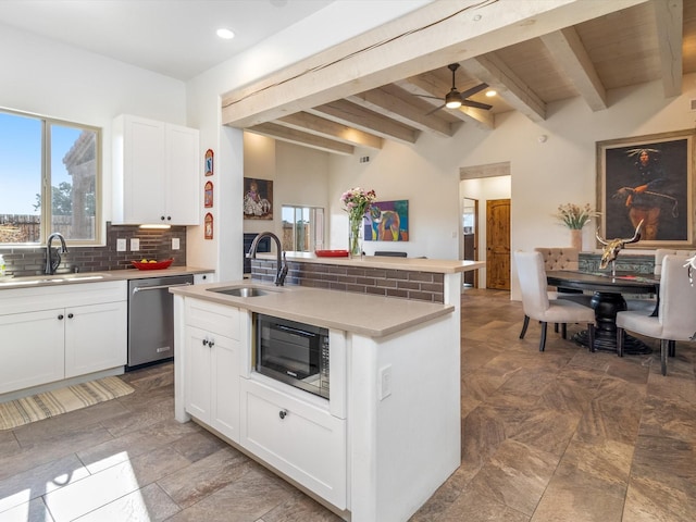 kitchen featuring white cabinetry, an island with sink, dishwasher, and sink