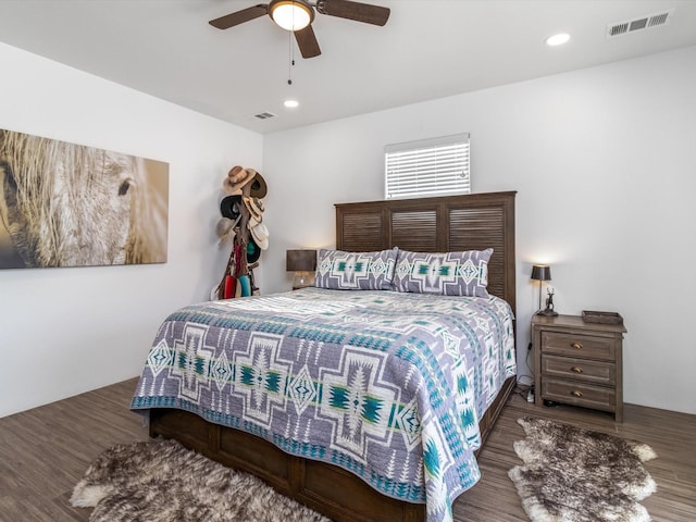 bedroom with ceiling fan and dark hardwood / wood-style flooring