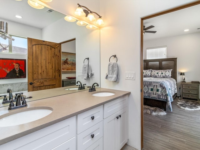 bathroom with hardwood / wood-style flooring, vanity, and a wealth of natural light