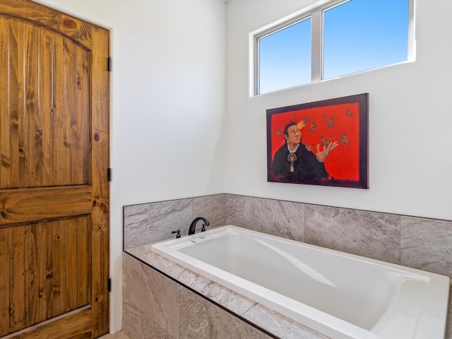 bathroom featuring a relaxing tiled tub