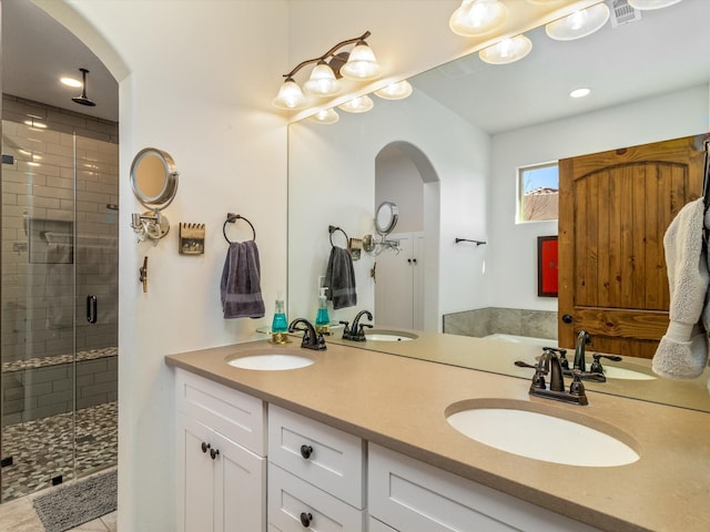 bathroom featuring vanity and a shower with door