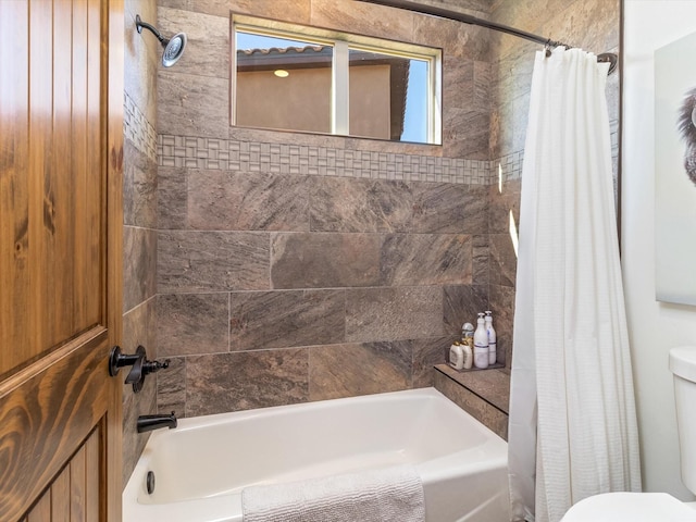 bathroom with toilet and shower / bath combo with shower curtain