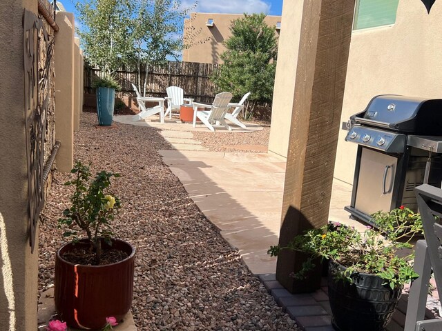 view of patio featuring a grill and a fire pit