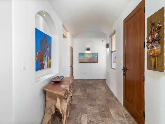 hallway featuring vaulted ceiling