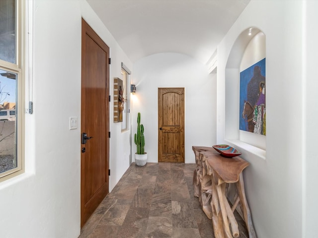 hallway with lofted ceiling