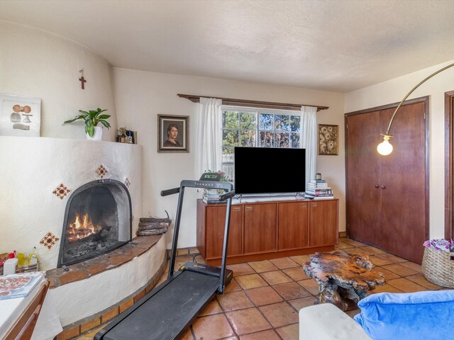 tiled living room featuring a textured ceiling