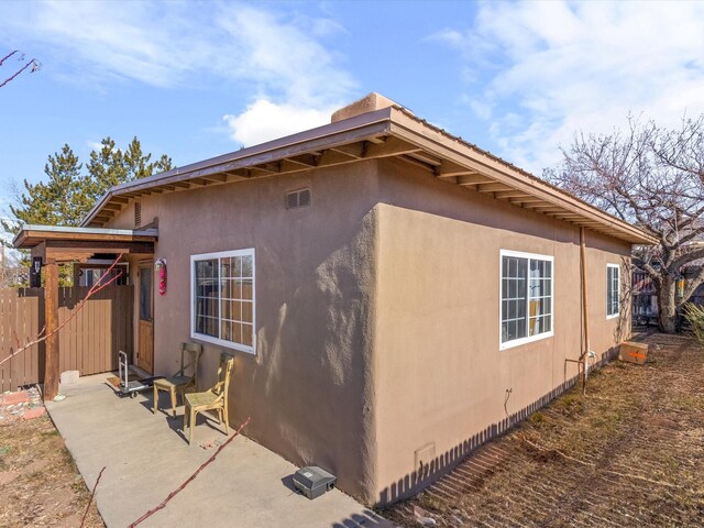 view of side of home with a patio area