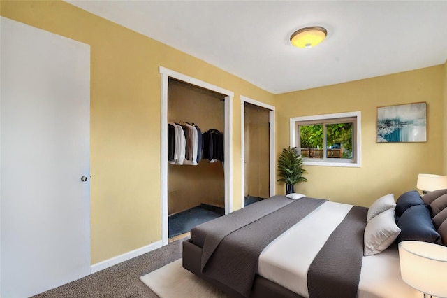 carpeted bedroom featuring two closets