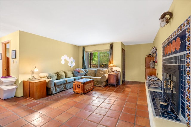 living room with a brick fireplace and tile patterned floors