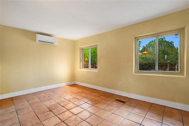 tiled empty room featuring an AC wall unit