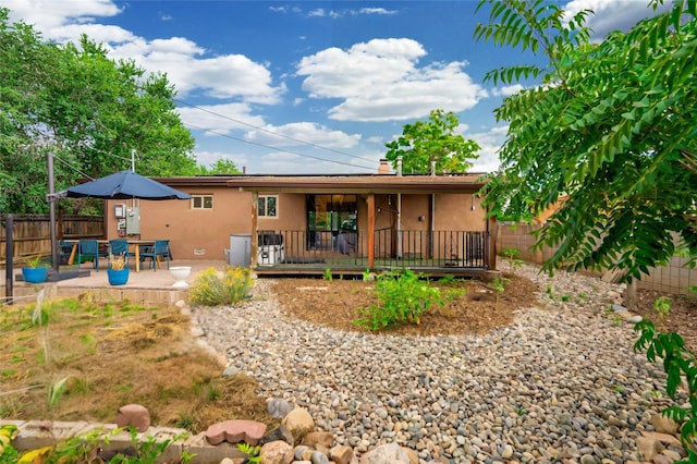 back of property with a patio